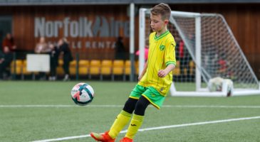 boy playing football in norwich city kit