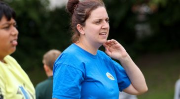 PE teacher watching outdoor PE lesson