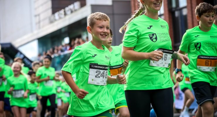 Children running in green tshirts