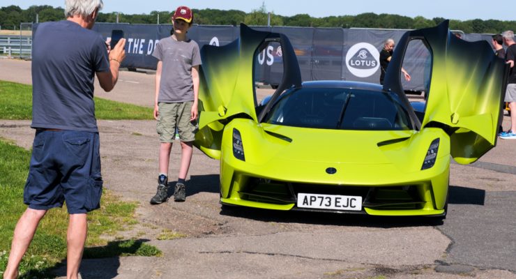 participant having a photo next to a lotus car