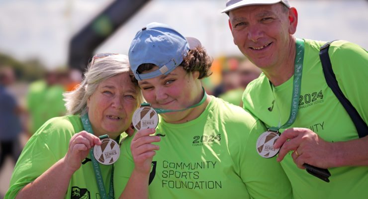 three participants with their medals