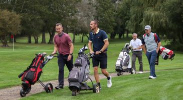 Four golfers walking 