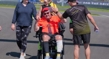 wheelchair participant high fiving lotus personnel