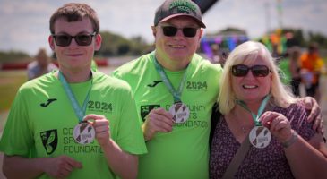 three participants with their medals