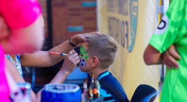 Boy getting his face painted