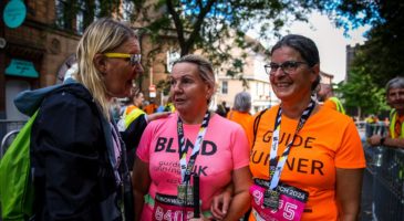 Two runners and a volunteer