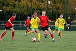 Two girls playing football