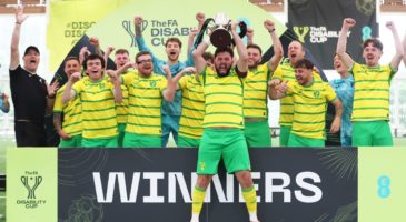 Norwich team lifting a trophy