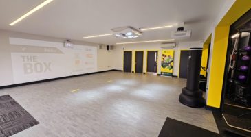 room with gym equipment and interactive wall