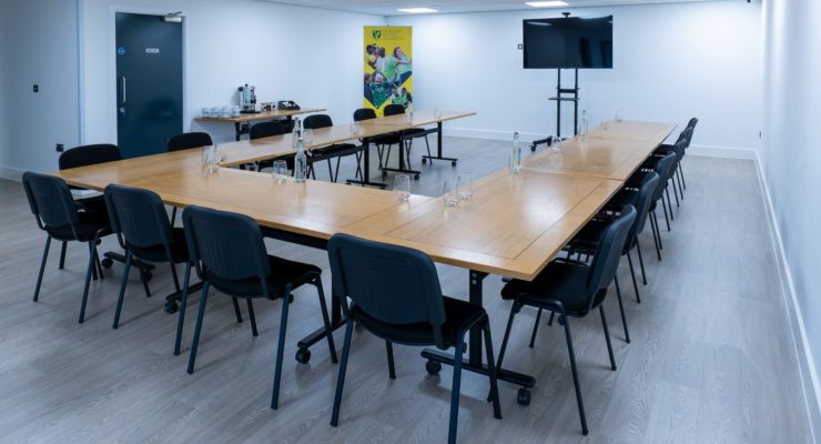 Meeting room set up in boardroom style with TV