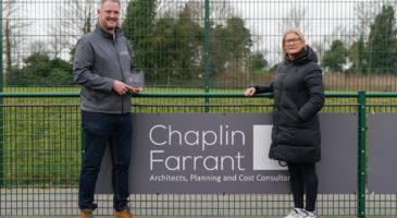 man and woman standing beside pitch board that read Chaplin Farrant